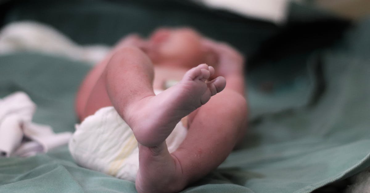 Close-up of a newborn's feet on a hospital bed, capturing the essence of new life.