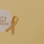 Minimalist design featuring a ribbon and 'Let's Beat Cancer' message for cancer awareness.
