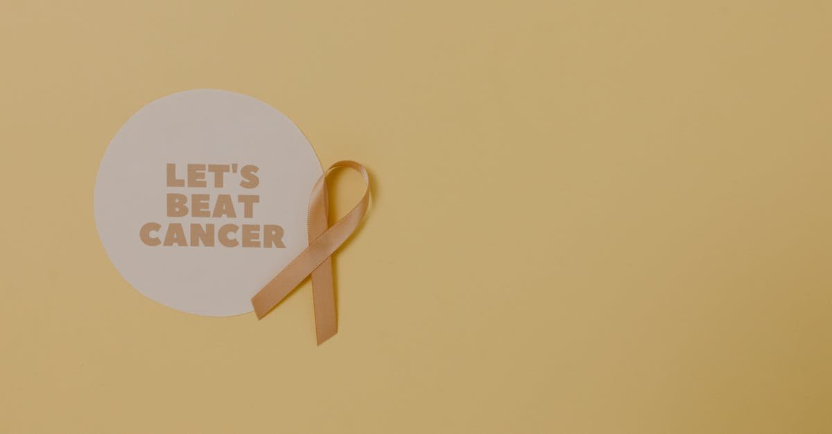Minimalist design featuring a ribbon and 'Let's Beat Cancer' message for cancer awareness.
