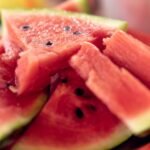 Close-up of fresh, sliced watermelons on a plate perfect for summer refreshment.
