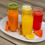Vibrant assorted fruit juices served on a plate with fresh fruits in Salamanca.