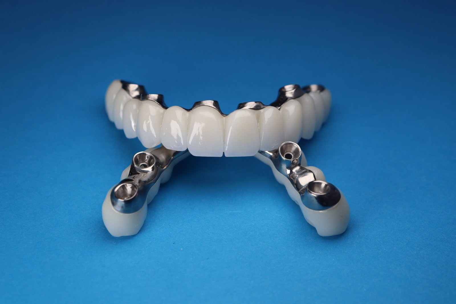 Rutgers PNAS Nexus study Georgios Kotsakis reveals bacteria corrode titanium implants releasing particles hijacking macrophages TRPC1 calcium channel triggering inflammation jawbone loss peri-implantitis treatment